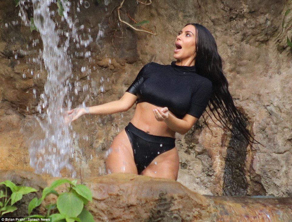 Bikini-clad Kim Kardashian squeals as she attempts to take a dip in a Waterfall