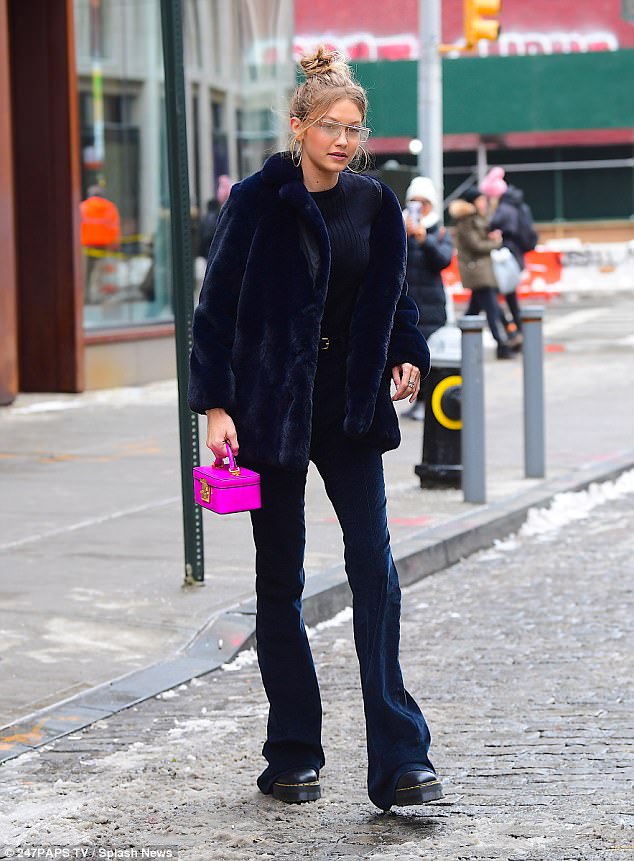 Gigi Hadid cuts effortlessly cool figure as she faces icy NYC in furry blue coat and neon pink purse