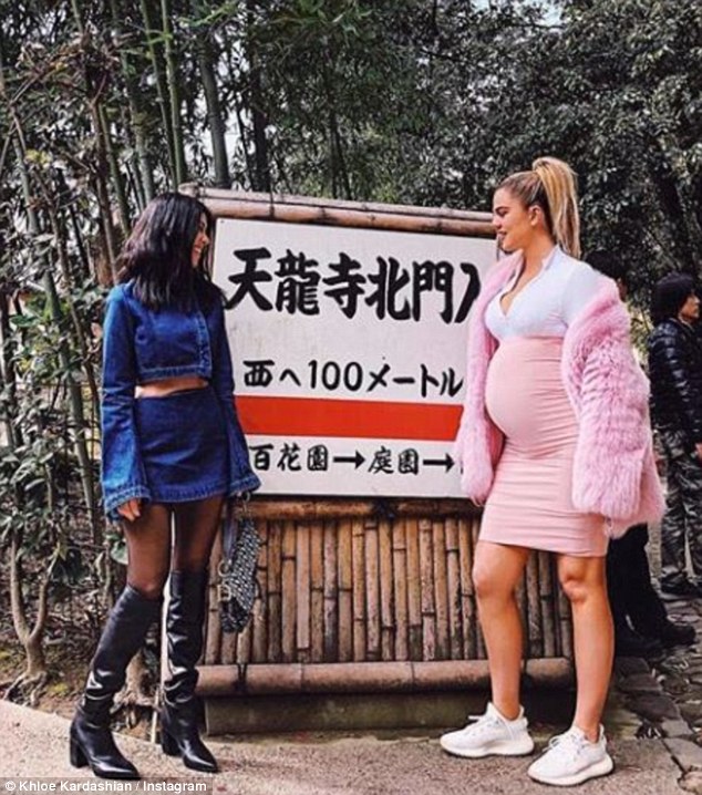 Pregnant Khloe Kardashian shows off growing baby bump as she is joined by Kourtney for Japanese landmark snap